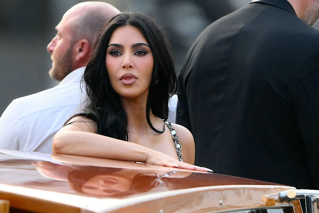 Kim Kardashian stands on a taxi boat as she leaves the Gritti Palace Hotel ahead of the wedding of Amazon's founder Jeff Bezos with Lauren Sanchez in Venice on June 26, 2026.