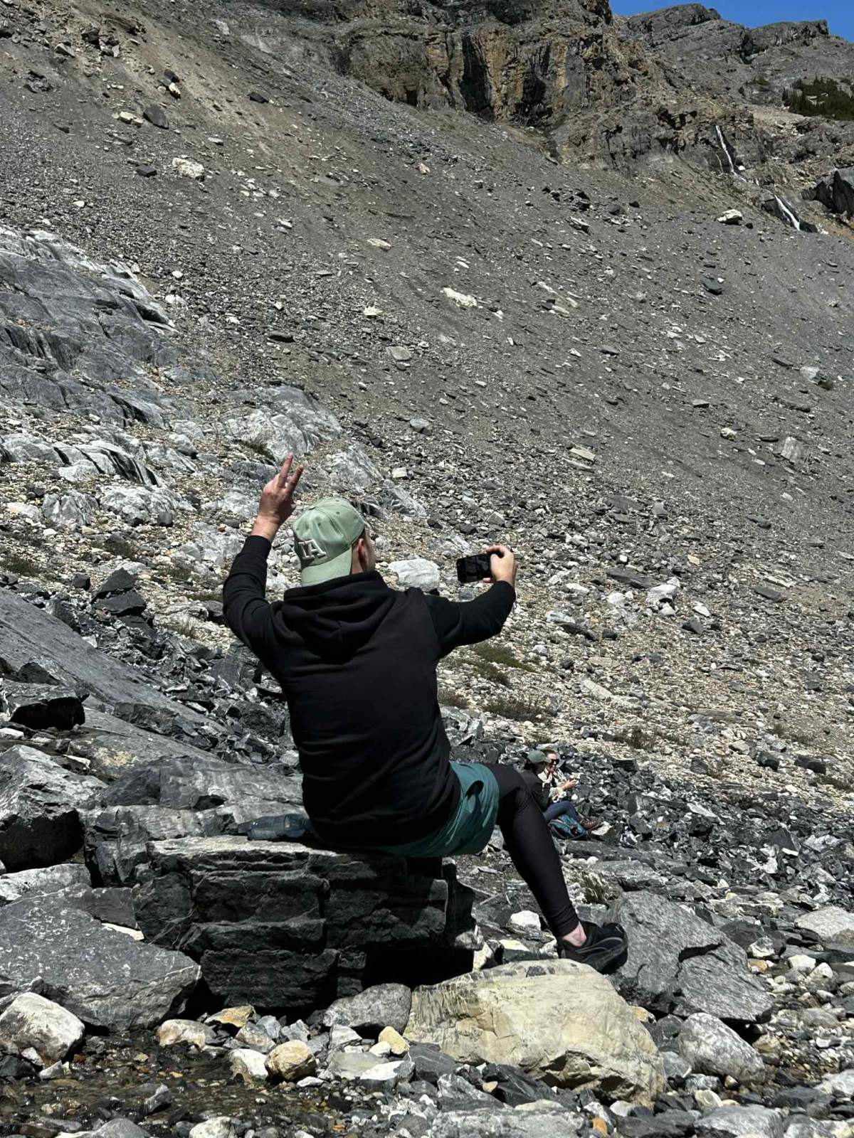 33-year-old Hamza Benhilal sits on rocks in front of the mountain at Bow Glacier Falls, where a massive rock slide would take his life a short time later.