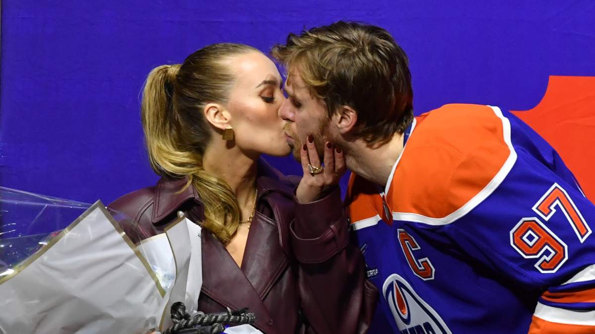 Edmonton Oilers captain Connor McDavid kisses his wife Lauren Kyle during his 1000th point ceremony prior to the game against the Columbus Blue Jackets at Rogers Place on December 5, 2024, in Edmonton. 