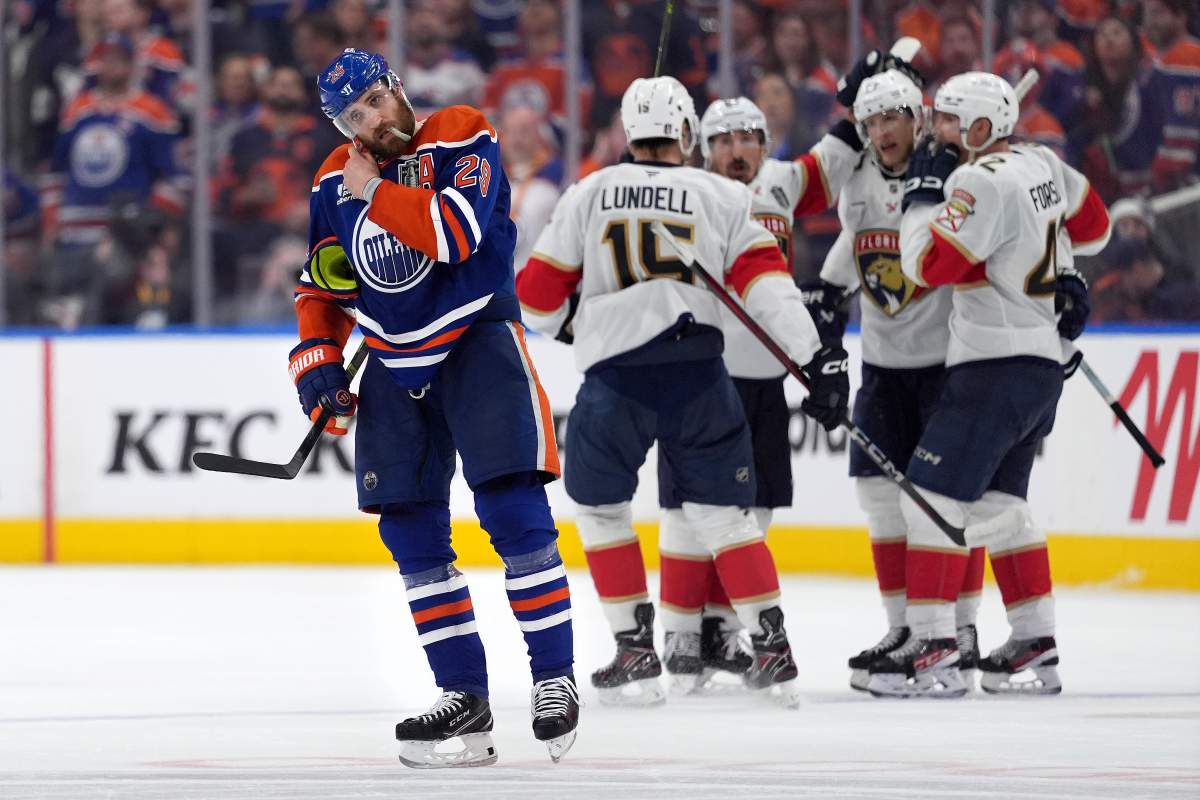 Edmonton Oilers centre Leon Draisaitl (29) skates to the bench as Florida Panthers centre Eetu Luostarinen (27) celebrates his empty-net goal with teammates during third period of Game Five NHL Stanley Cup hockey finals in Edmonton, Saturday, June 14, 2025.