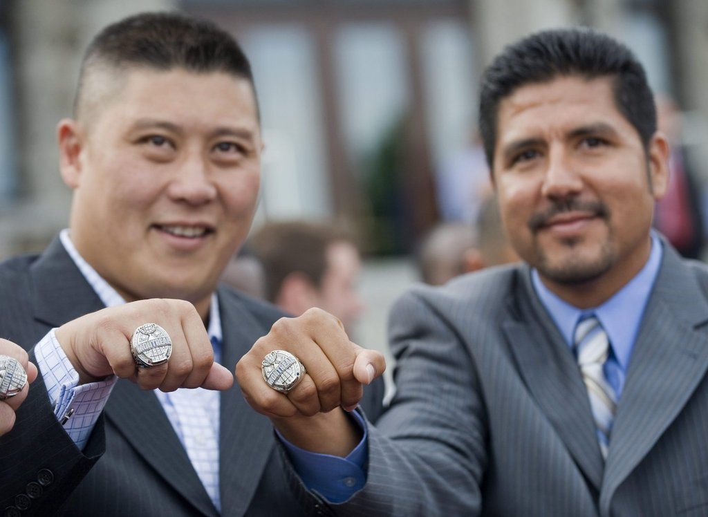 Montreal Alouettes' quarterback Anthony Calvillo, right, and Alouettes' veteran centre Bryan Chiu display their 2009 Grey Cup rings during a ceremony in Montreal on June 4, 2010.