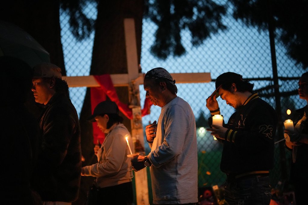 People gather for a candlelight march for victims of the Lapu Lapu Day attack during a vigil in Vancouver, B.C., Friday, May 2, 2025. THE CANADIAN PRESS/Darryl Dyck.
