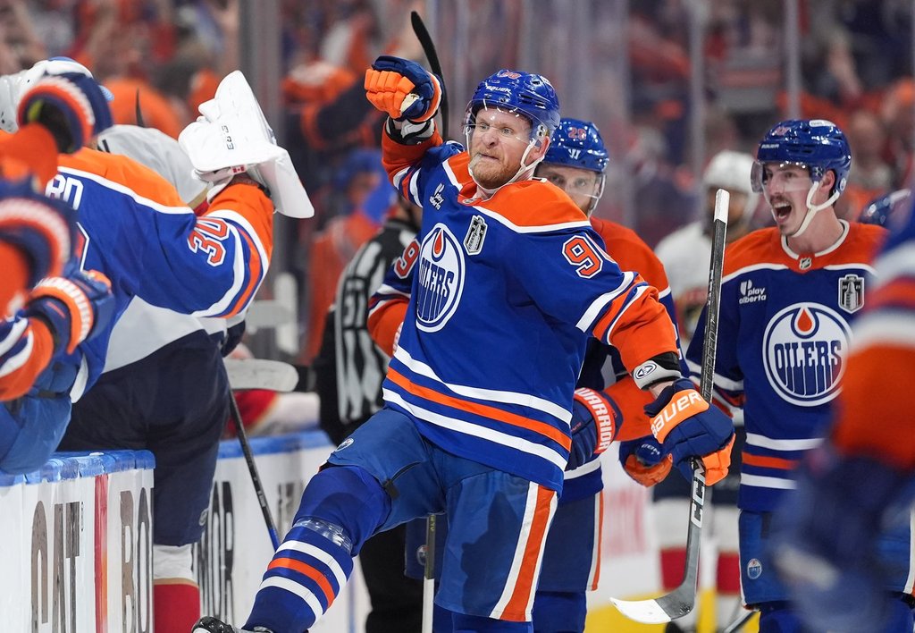 Oilers forwards Corey Perry (90) and Ryan Nugent-Hopkins, back right, celebrate Perry's tying goal against the Florida Panthers during the third period in Game 2 of the Stanley Cup final in Edmonton, on Friday, June 6, 2025.