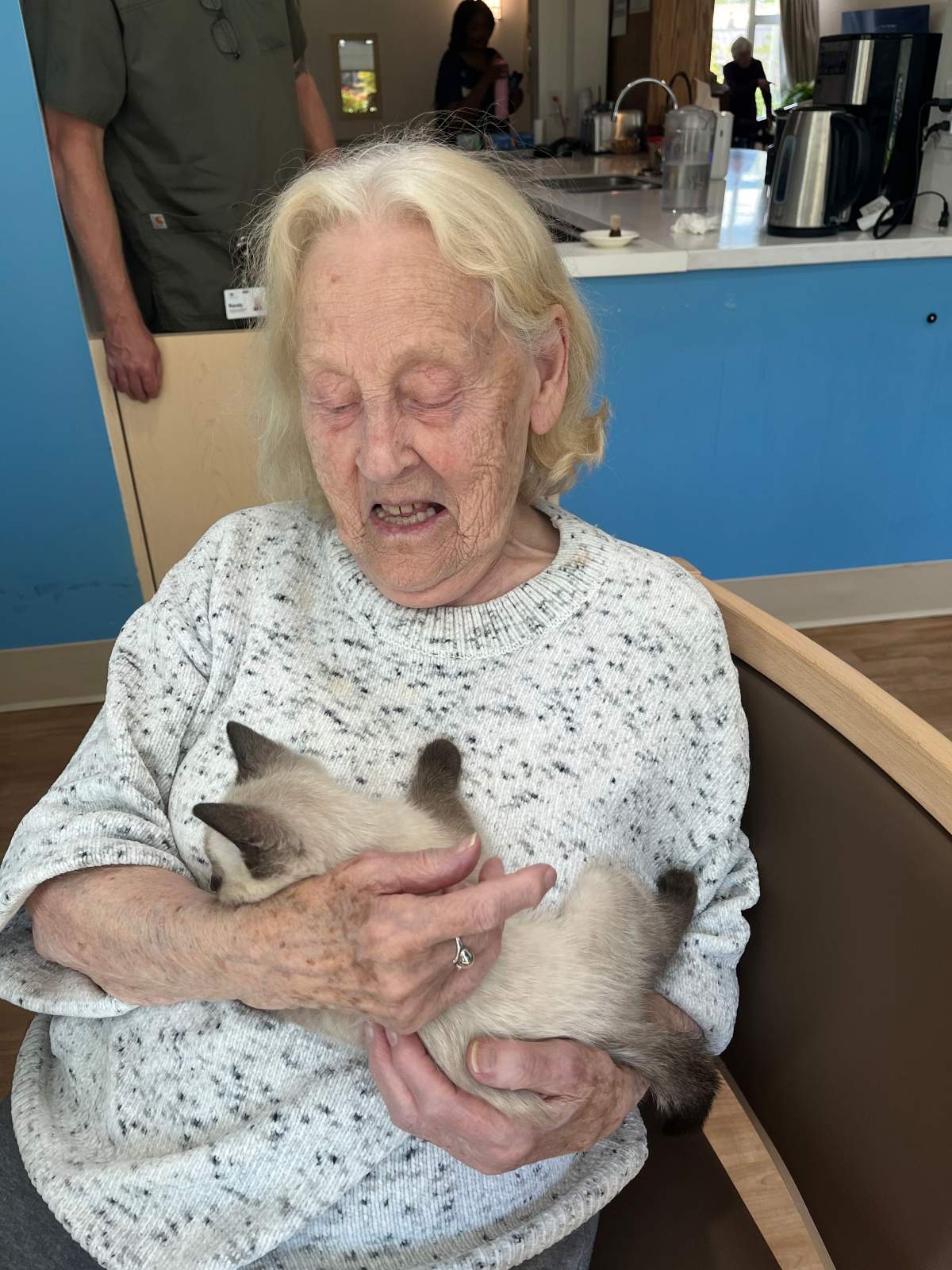 A kitten cuddles with a woman who lives at The Views in Comox.