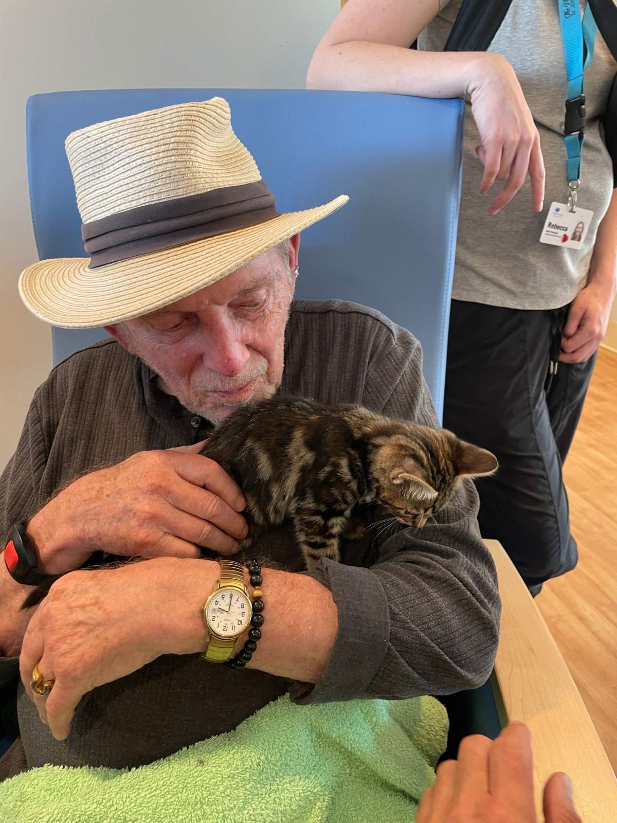 A resident of The Views cuddles with a kitten.