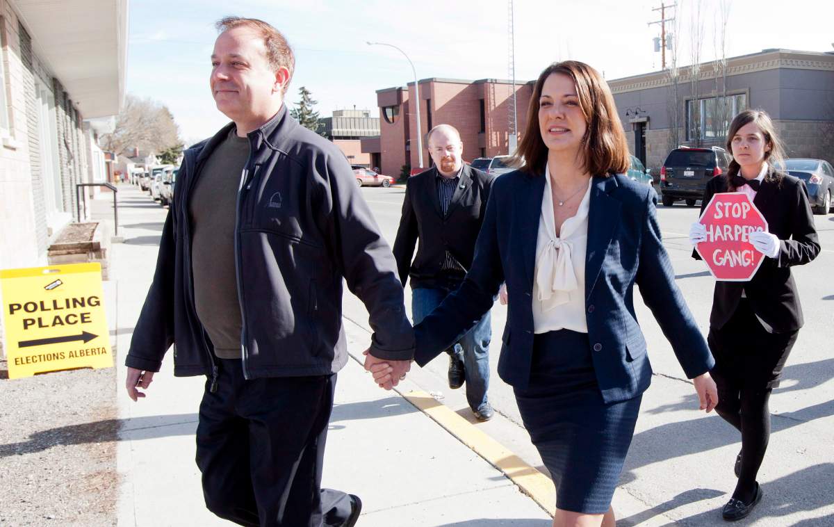 Then-Wildrose Leader Danielle Smith leaves a polling station with her husband David Moretta, left, in High River, Alberta to cast her ballot for the Alberta election Monday, April, 23, 2012.
