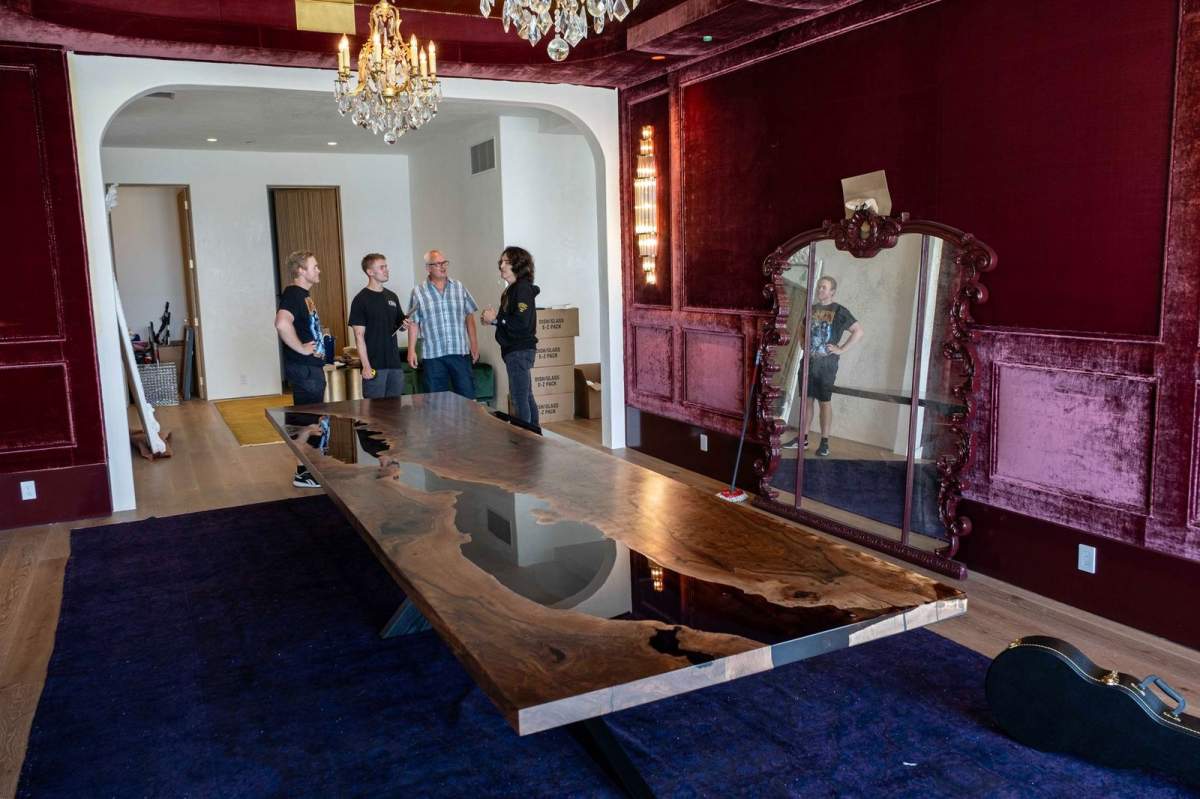 The table, custom made from walnut and resin is about 5 metres long, a metre and a half wide and weighs close to 500 kilograms.