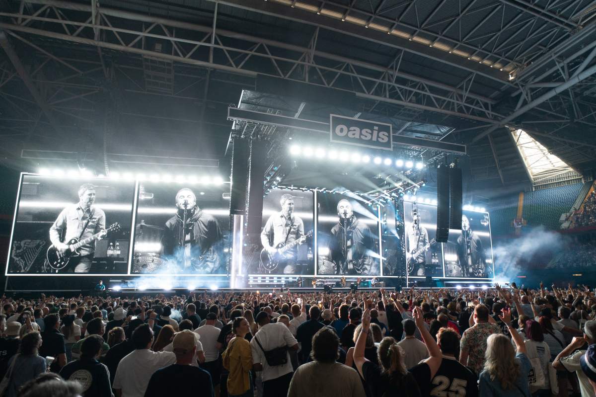 British rock band Oasis perform on stage at the Principality Stadium in Cardiff on July 4, 2025, during the opening concert of their highly anticipated reunion tour nearly 16 years after last performing together.