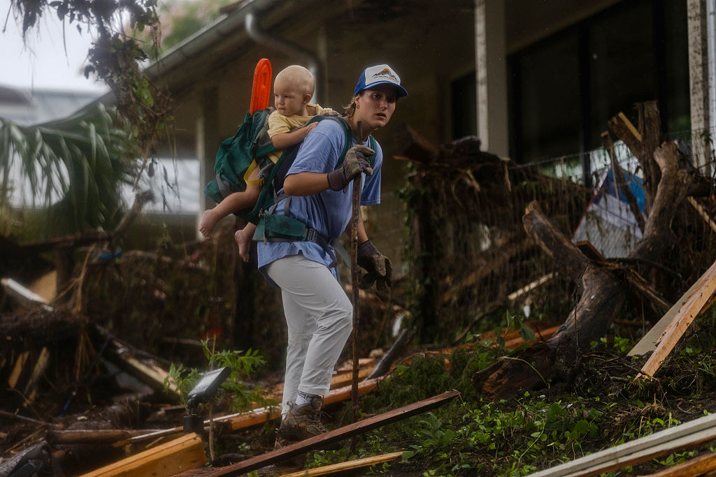 A search and rescue worker looks through debris for any survivors or remains of people swept up in the flash flooding on July 6, 2025 in Hunt, Texas.