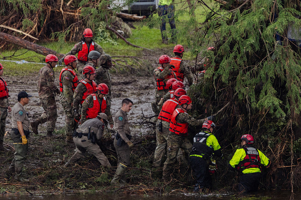 Search and recovery workers dig through debris looking for any survivors or remains of people swept up in the flash flooding at Camp Mystic on July 6, 2025 in Hunt, Texas.