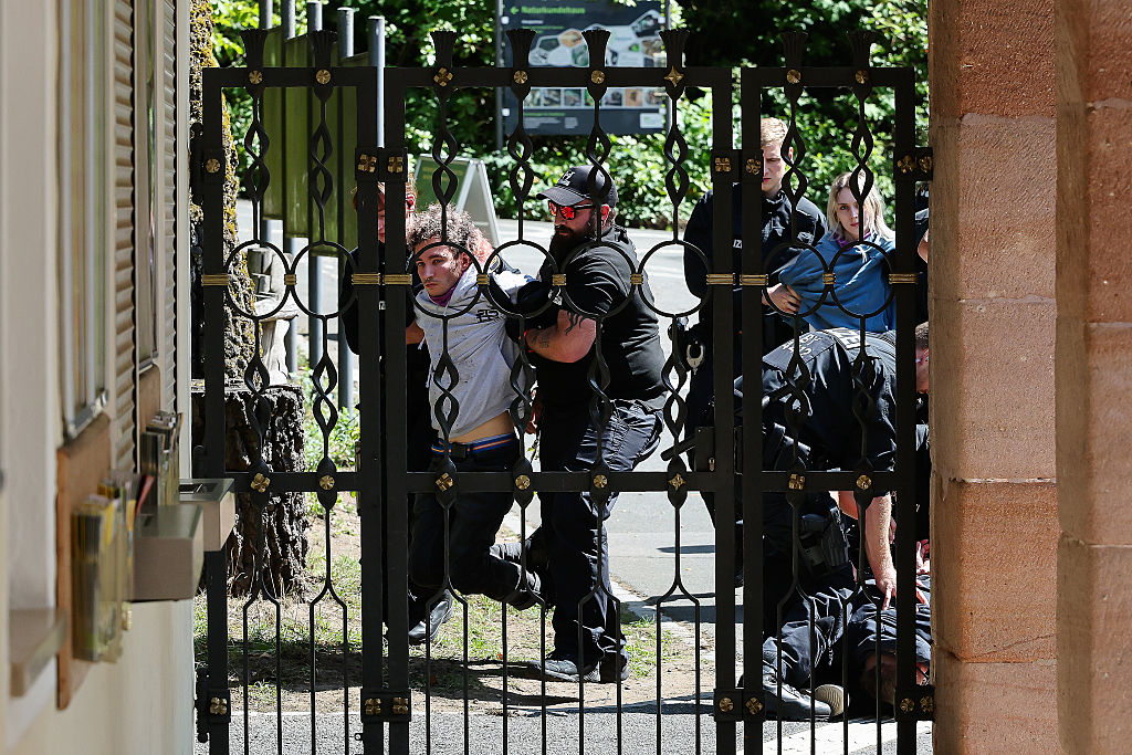 Demonstrators from Animal Rebellion are arrested by the police after entering the grounds of Nuremberg Zoo.
