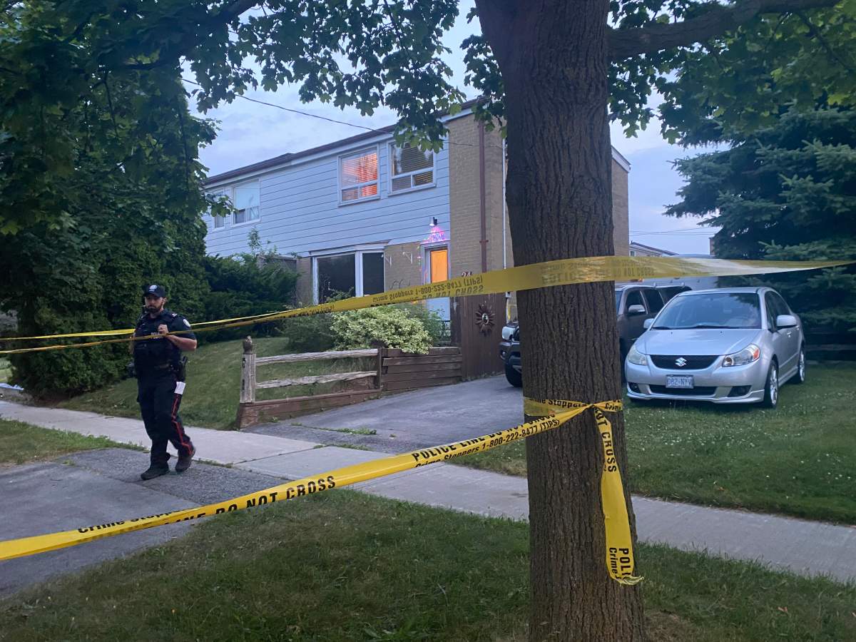 Police at the scene of a home where two men were found dead.