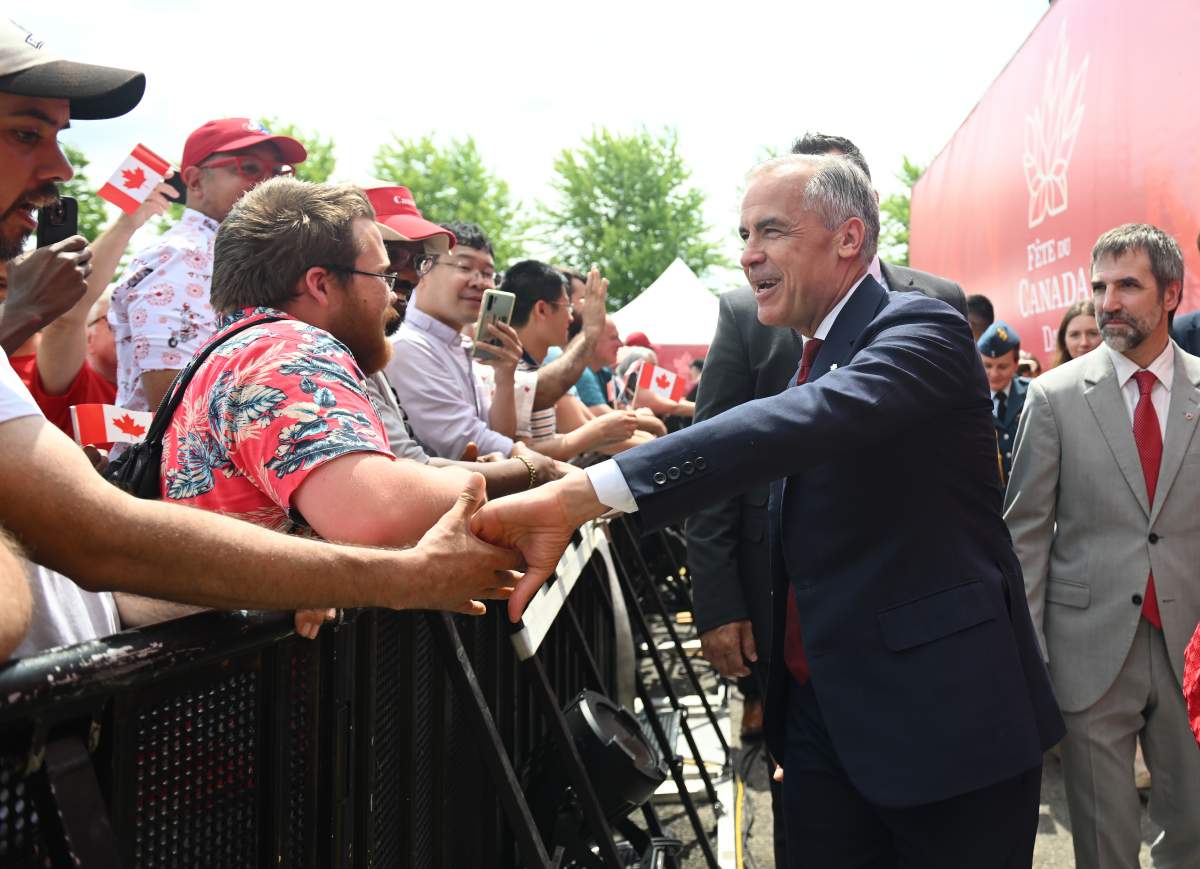 Prime Minister Mark Carney greets members of the public during Canada Day celebrations at LeBreton Flats in Ottawa on Tuesday, July 1, 2025. THE CANADIAN PRESS/Spencer Colby