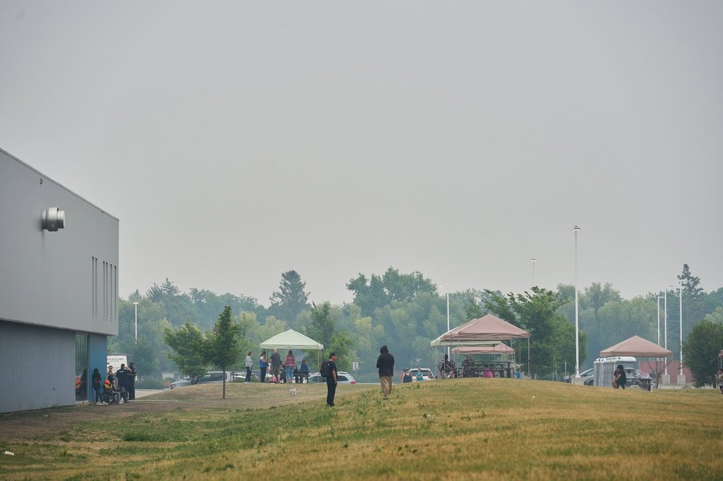 Wildfire evacuees are seen outside of the primary evacuation reception centre at the Leila Soccer Complex in Winnipeg, on Friday, July 11, 2025.  