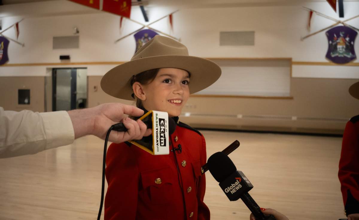 Tessa wearing her tailored Red Serge and talking to media in Regina.