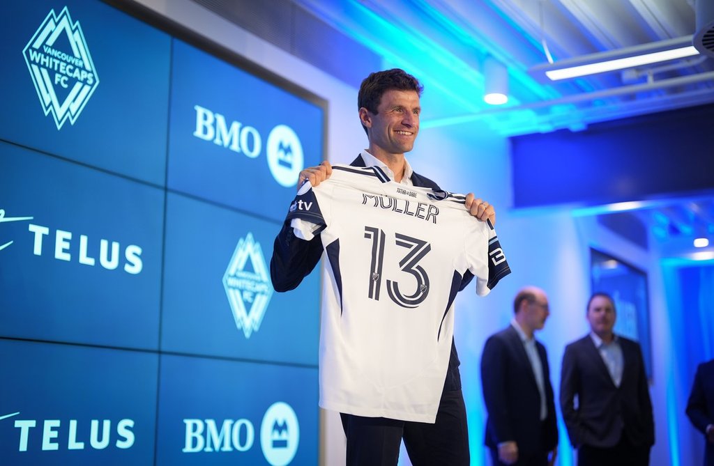 New Vancouver Whitecaps player Thomas Muller poses with his jersey during a news conference in Vancouver on Aug. 14, 2025. THE CANADIAN PRESS/Darryl Dyck.