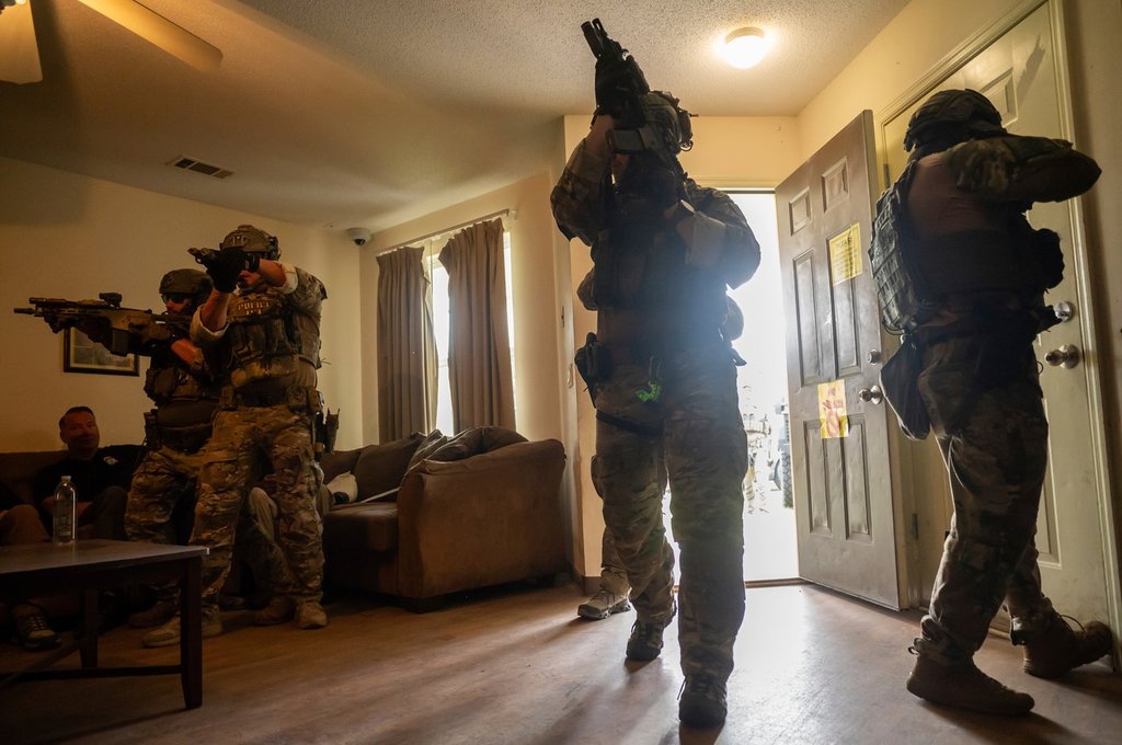 Immigration and Customs Enforcement (ICE) Special Response Team members demonstrate how the team enters a residence in the pursuit of a wanted subject at the Federal Law Enforcement Training Centers (FLETC) in Brunswick, Ga. on Thursday, Aug. 21, 2025.