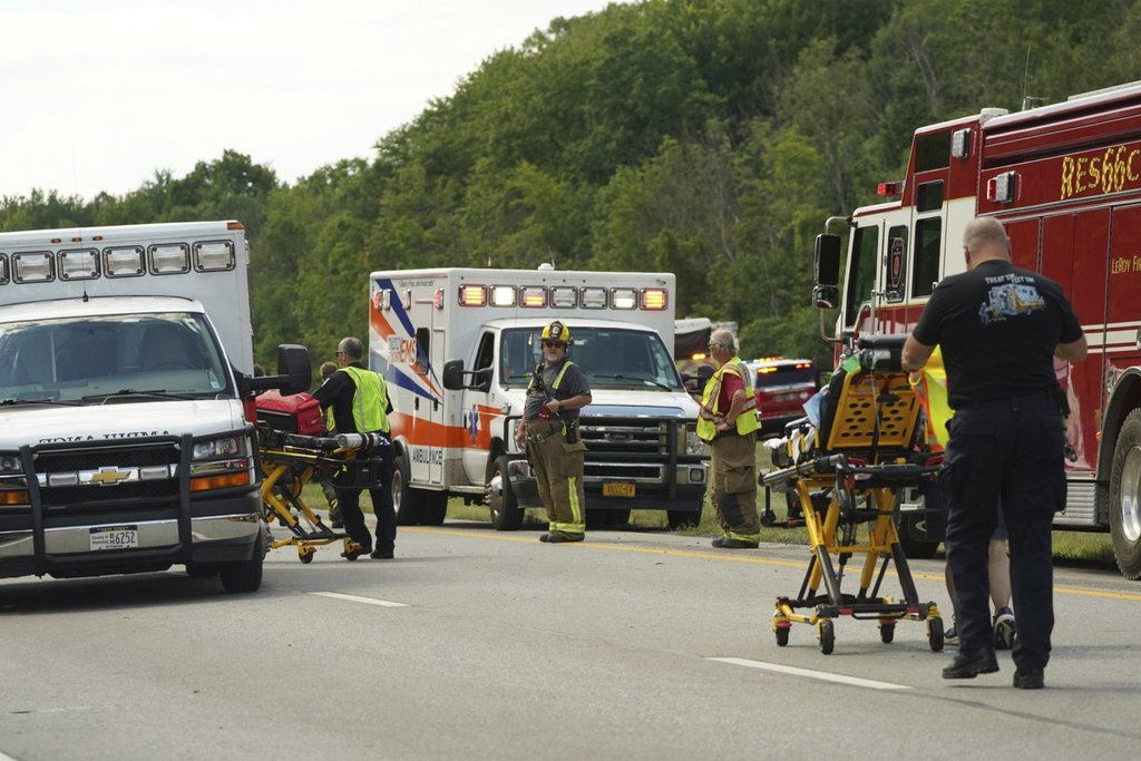 Rescue personnel work the scene of a tour bus that crashed and rolled over on the New York State Thruway near Pembroke, N.Y., Friday, Aug. 22, 2025. (Libby March/Buffalo News via AP)