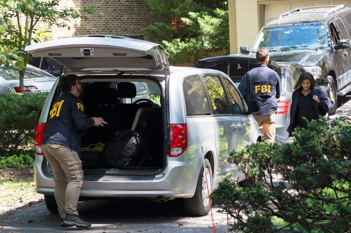 A group of FBI agents leave former national security adviser John Bolton's house where FBI searched the home, Friday, Aug. 22, 2025, in Bethesda, Md. (AP Photo/Manuel Balce Ceneta).