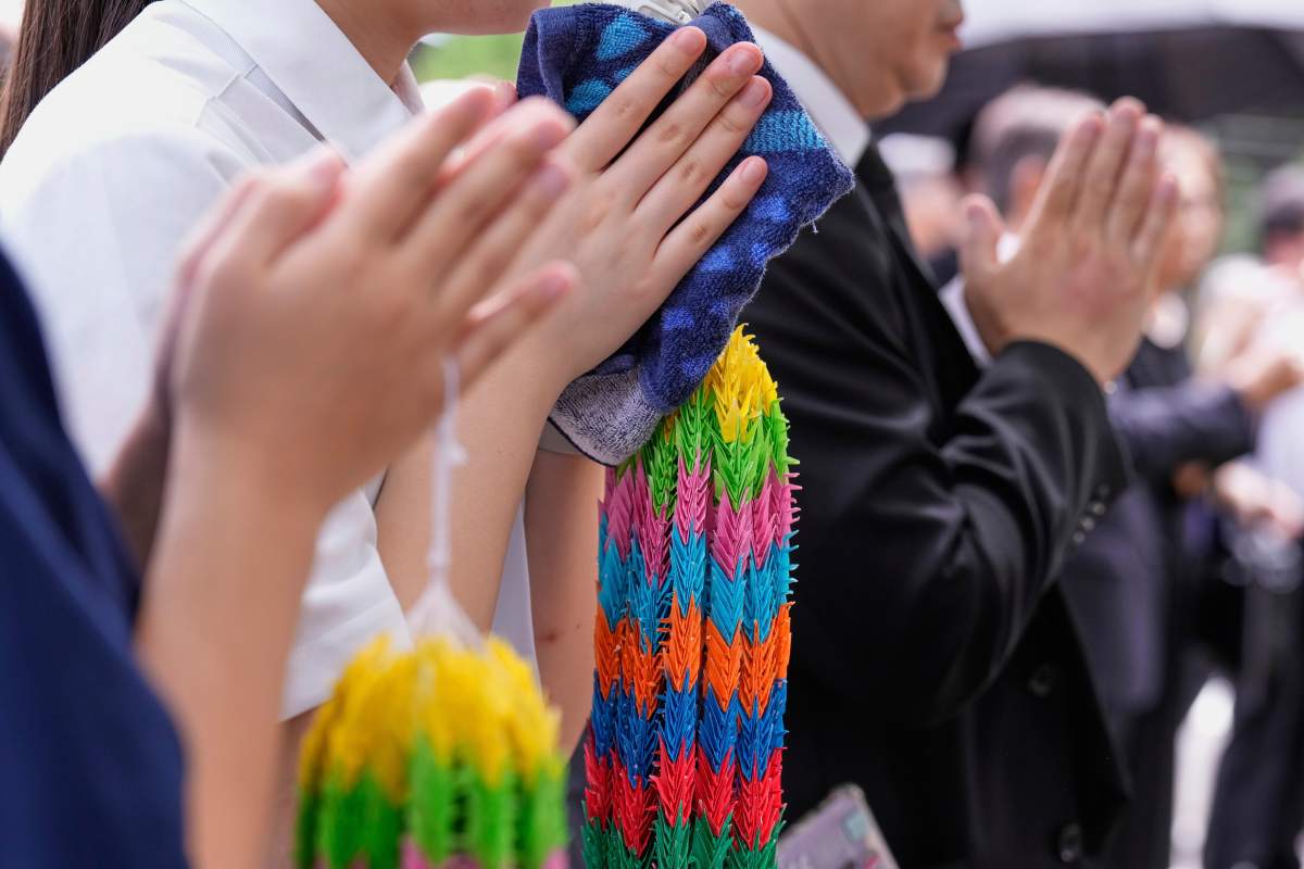 South Korean residents living in Japan and Japanese guests observe a minute of silence for the victims of the atomic bombing, during a memorial service for Korean atomic bomb victims ahead of a ceremony to mark the 80th anniversary of the bombing near Nagasaki Peace Park, Friday, Aug. 8, 2025, in Nagasaki, western Japan.