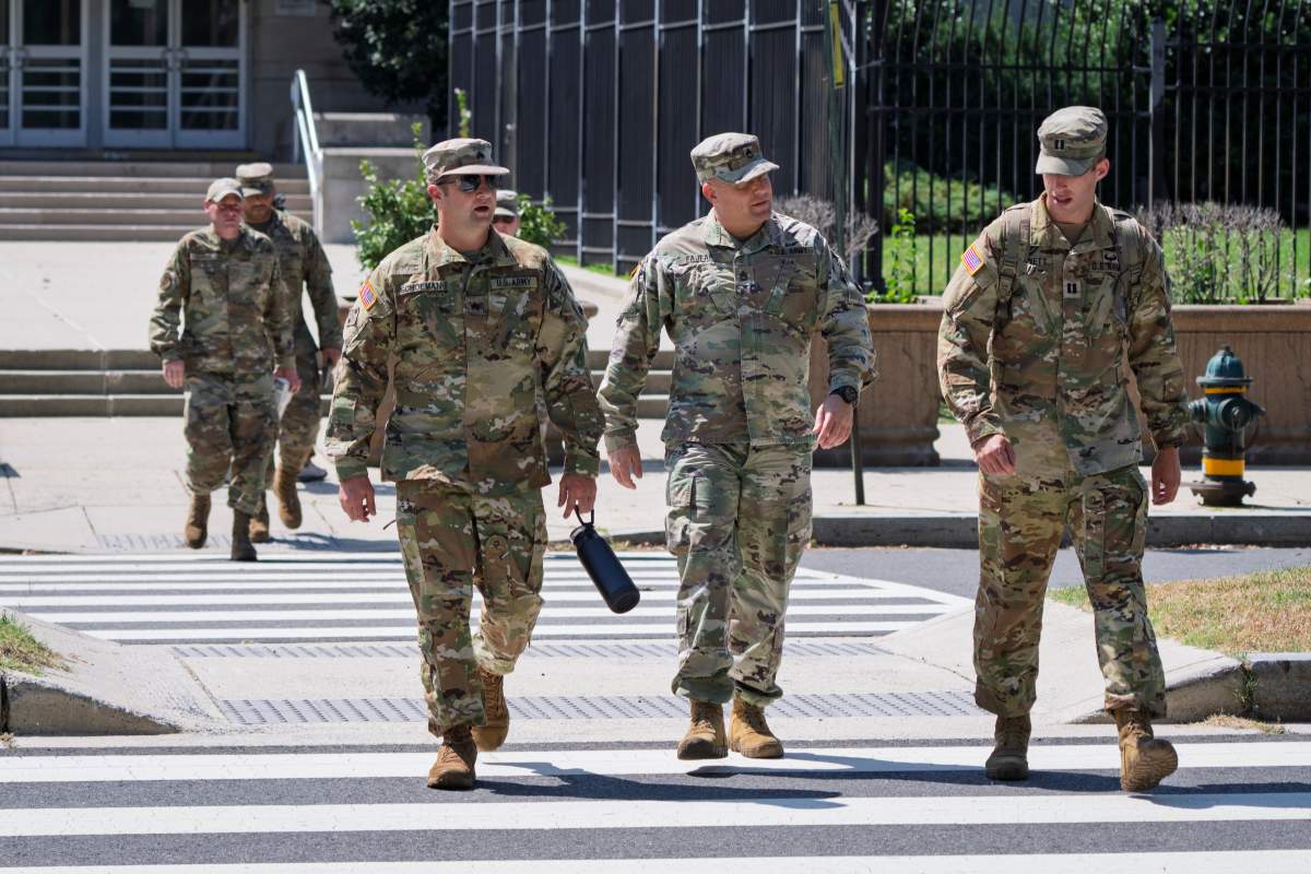 Military personnel depart the District of Columbia National Guard Headquarters as U.S. President Donald Trump implements his order to use federal law enforcement and the National Guard to expel homeless people and rid the nation's capital of violent crime, in Washington, Tuesday, Aug. 12, 2025.