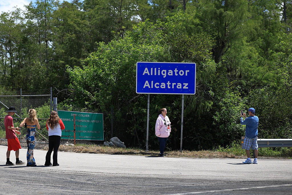 Alligator Alcatraz sign at the entrance to the Dade-Collier Training and Transition Airport on July 10, 2025 in Ochopee, Florida. The site is the location of the state-managed immigration detention facility in the Florida Everglades.
