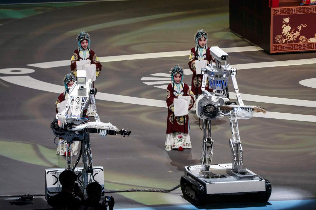 Humanoid robots play instruments during the opening ceremony of the World Humanoid Robot Games in Beijing, China, on Thursday, Aug. 14, 2025.