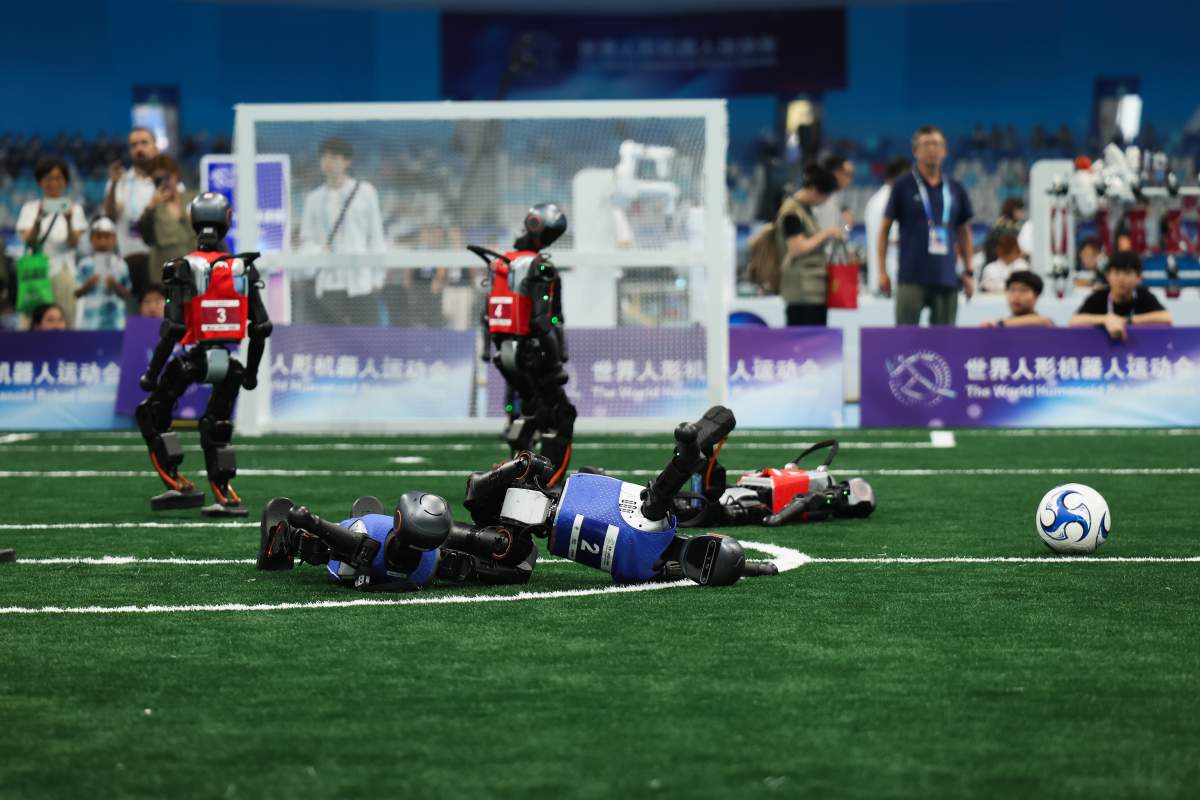 Humanoid robots compete in the 5v5 soccer during the day one of 2025 World Humanoid Robot Games at National Speed Skating Oval on August 15, 2025 in Beijing,