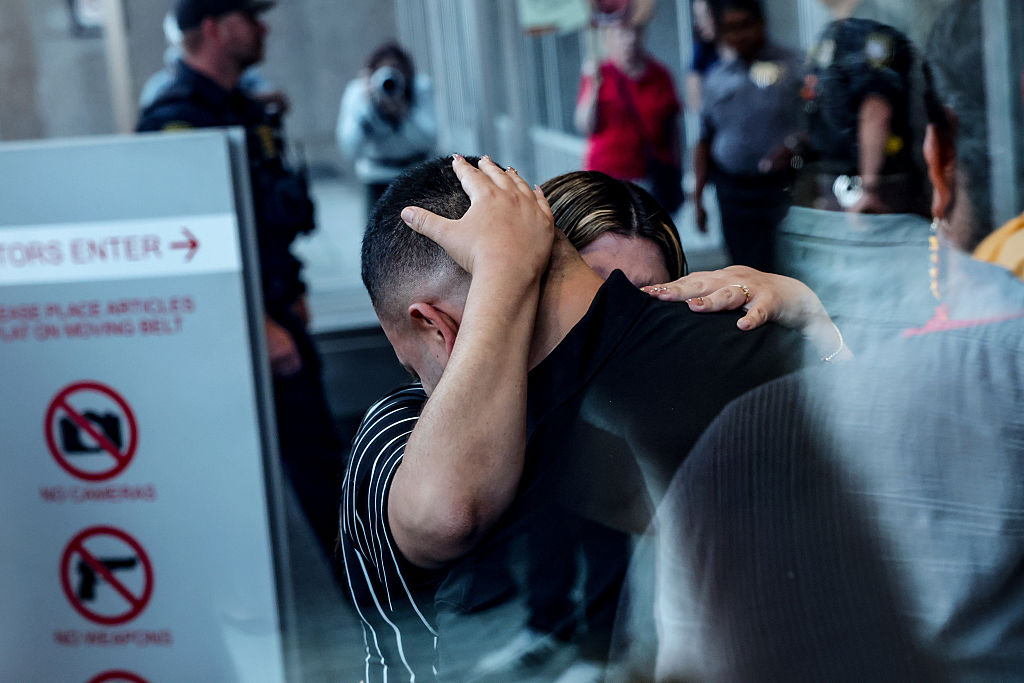 Kilmar Abrego Garcia hugs his wife Jennifer Vasquez Sura inside a U.S. Immigration and Customs Enforcement (ICE) field office on August 25, 2025 in Baltimore, Maryland.