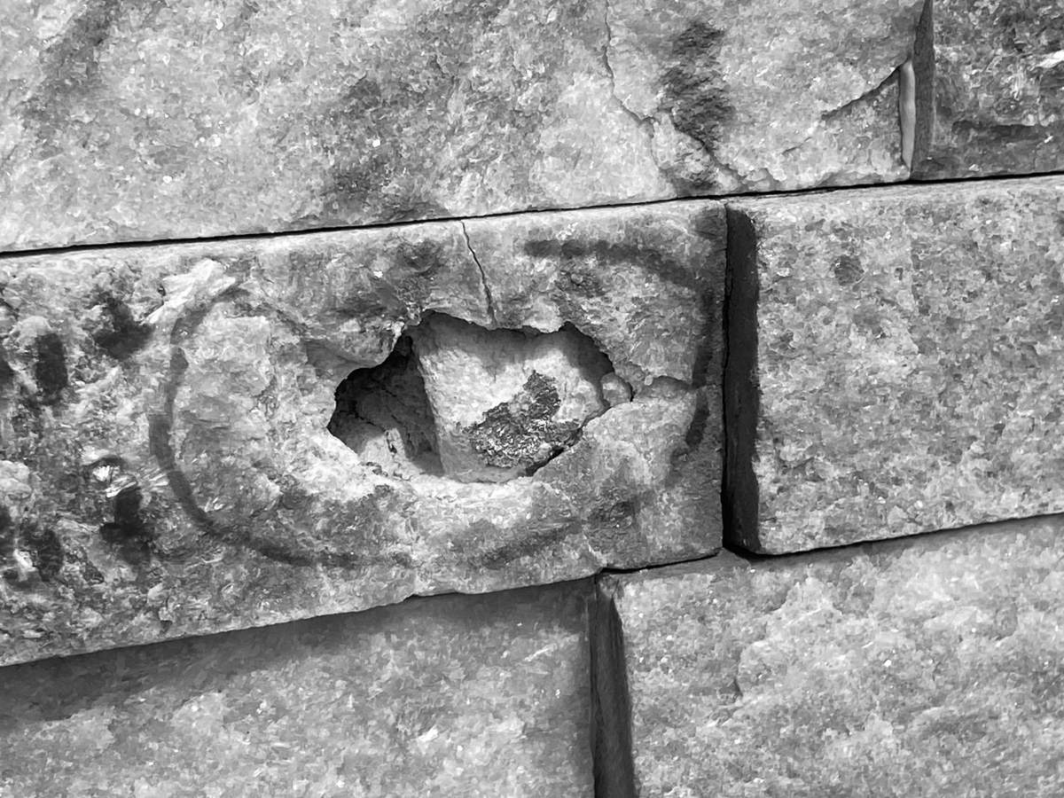A bullet hole in a home in Leduc County on Friday, August 8, 2025. Global News has converted this photo to black and white so the home is less recognizable.