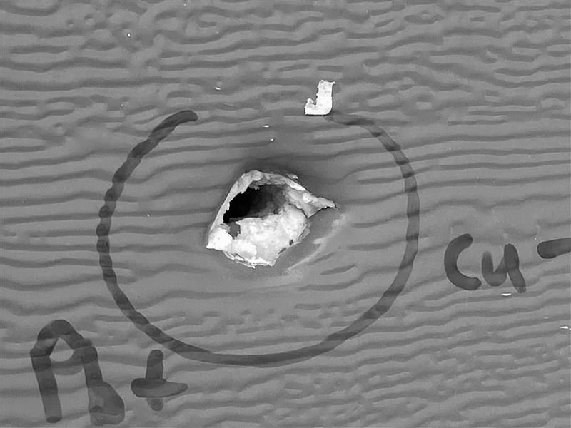 A bullet hole in a home in Leduc County on Friday, August 8, 2025. Global News has converted this photo to black and white so the home is less recognizable.