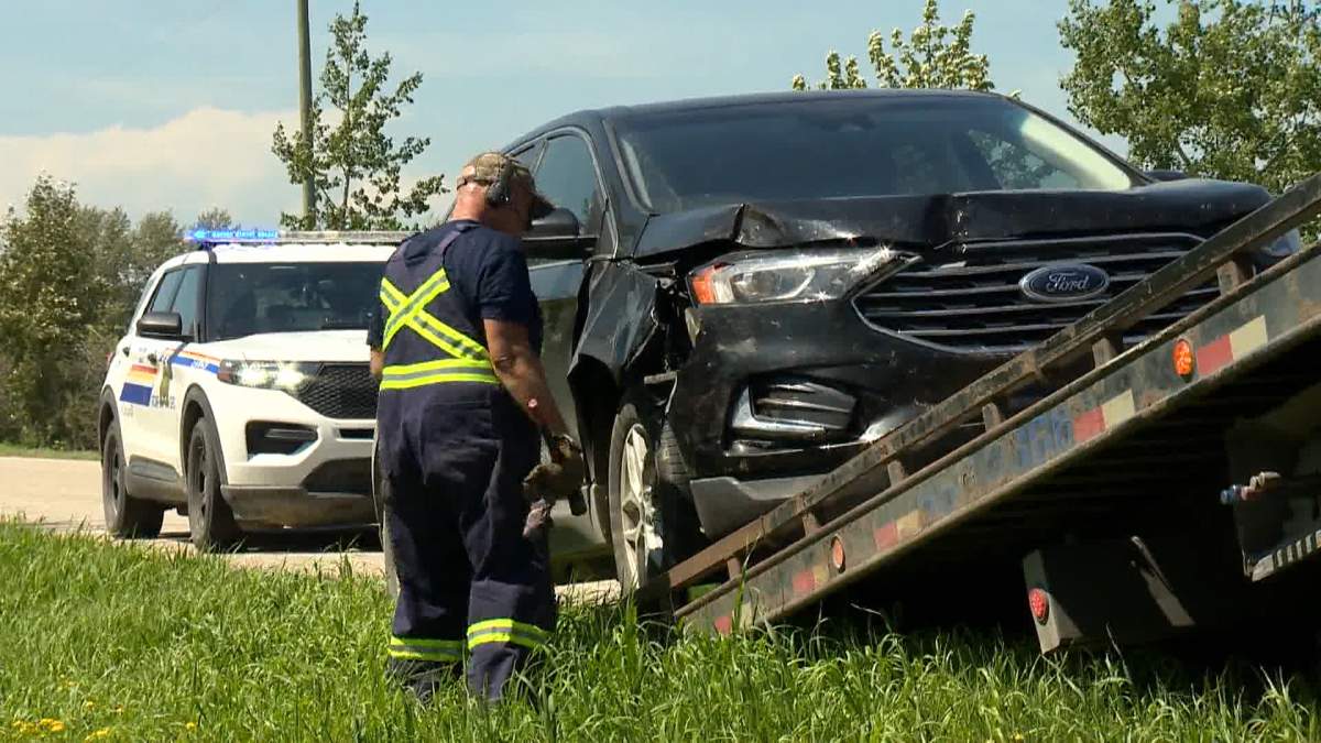 The RCMP prepare to tow away a vehicle, believed to be stolen, after officers were called to an area northwest of Bowden, Ab. on Friday morning for reports of a man attempting to light a fire along a rural road.