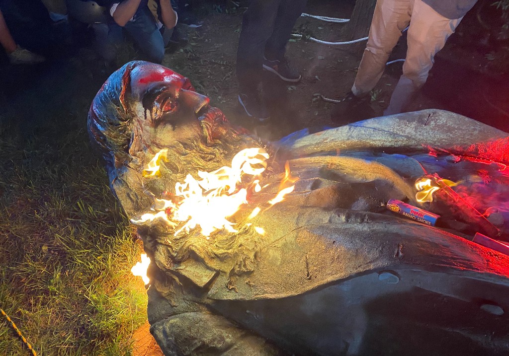 Demonstrators set fire to the Albert Pike Statue after being toppled in Washington, DC on June 19, 2020.