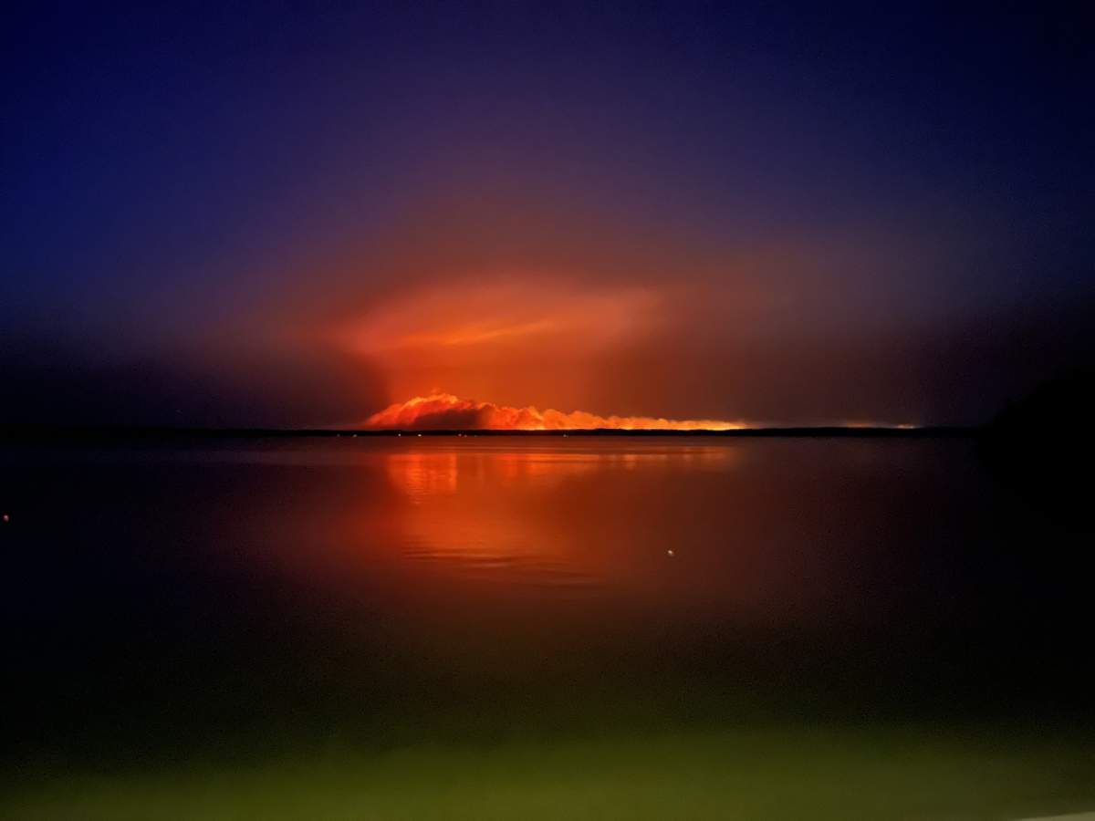 The wildfire on the Manitoba-Ontario border lights up the water and sky in May.