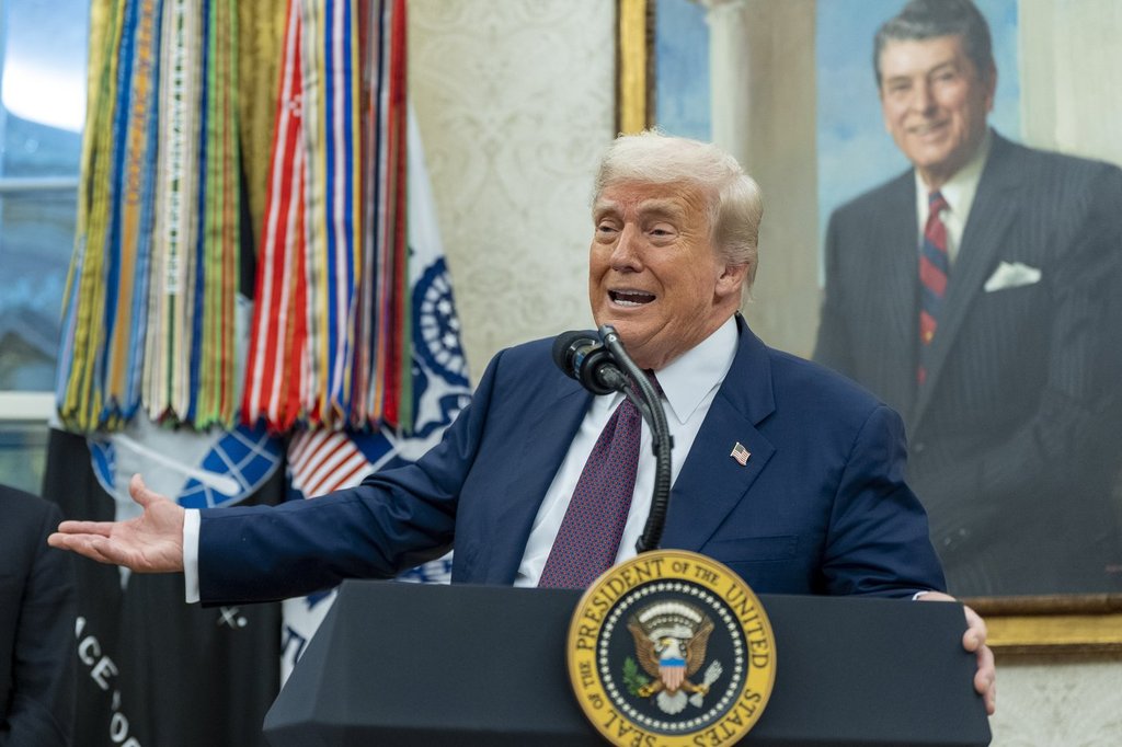 President Donald Trump speaks while making an announcement about Apple with Apple CEO Tim Cook in the Oval Office, Wednesday, Aug. 6, 2025, in Washington. (AP Photo/Alex Brandon).