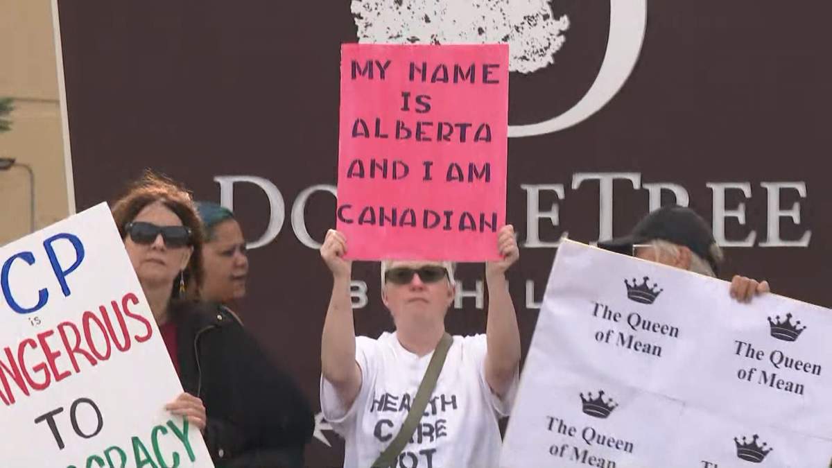 A group of protestors opposed the Alberta separation gather outside a town hall hosted by the Alberta Next panel in Edmonton on Thursday, Aug. 14, 2025.