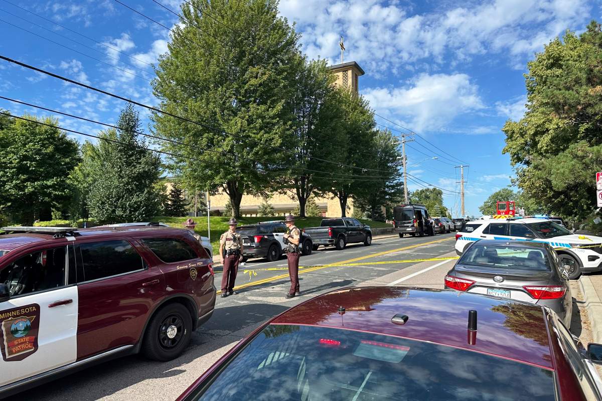 Law enforcement officers gather outside the Annunciation Church's school in response to a reported mass shooting, Wednesday, Aug. 27, 2025, in Minneapolis.