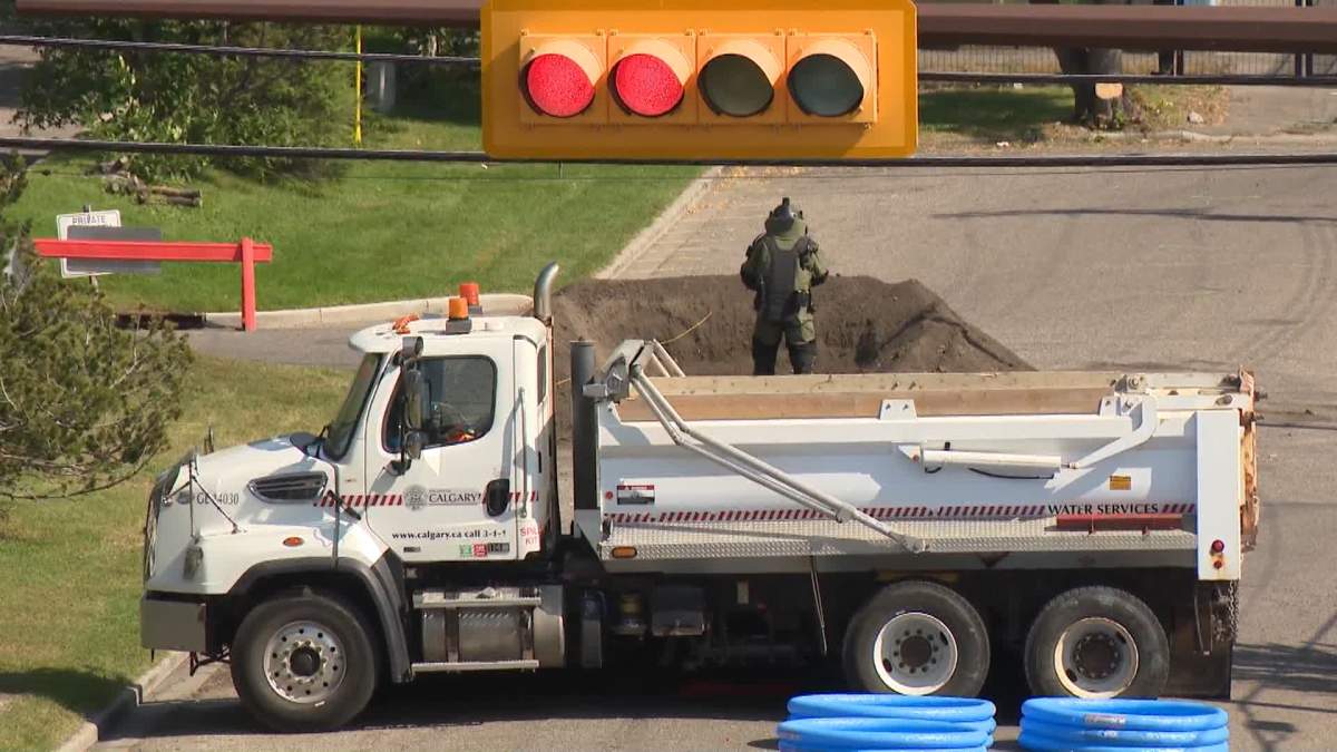 A member of the CPS bomb disposal unit is seen Wednesday afternoon preparing to conduct a controlled explosion on some hazardous chemicals that forced several blocks of Calgary's Manchester industrial park to be evacuated.