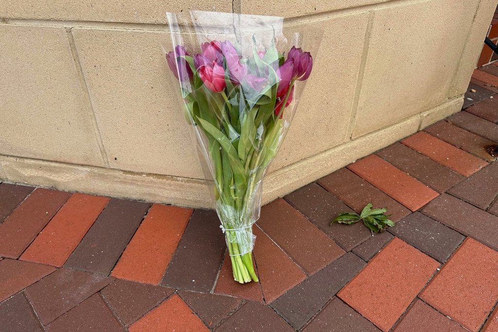A lone bouquet sits outside a CVS pharmacy on Saturday, Aug. 9, 2025, near where police say a man was shooting at the headquarters of the U.S. Centers for Disease Control and Prevention in Atlanta.