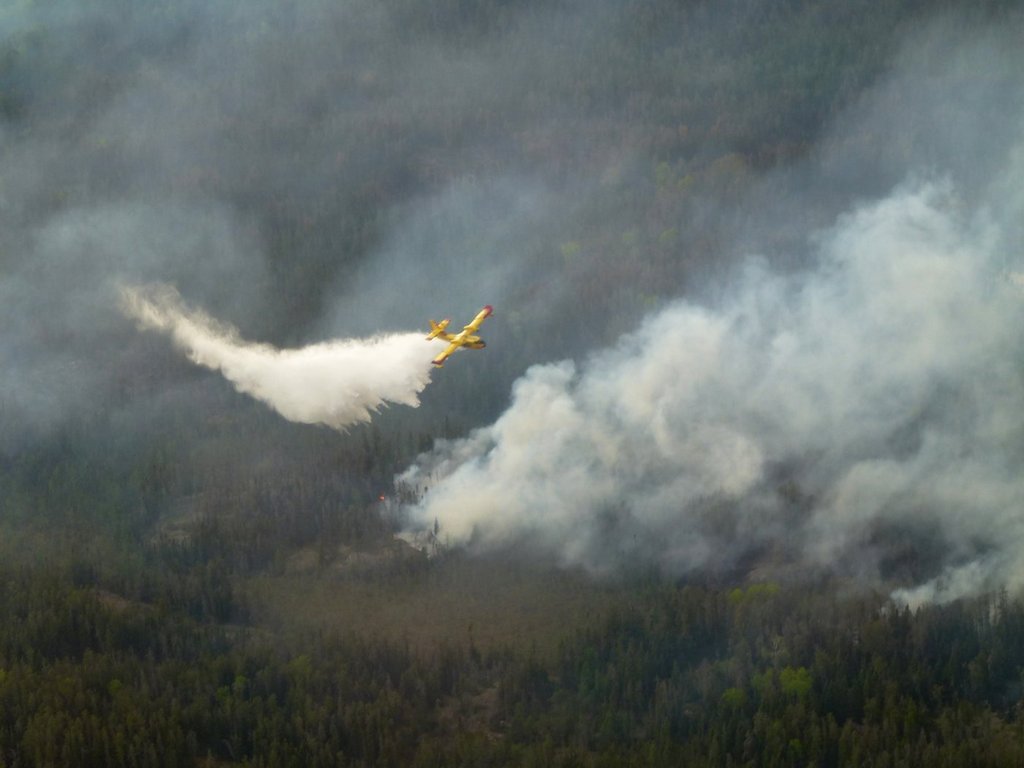 A water bomber aircraft battles a wildfire in southeast Manitoba as shown in this handout photo provided by the Manitoba government.