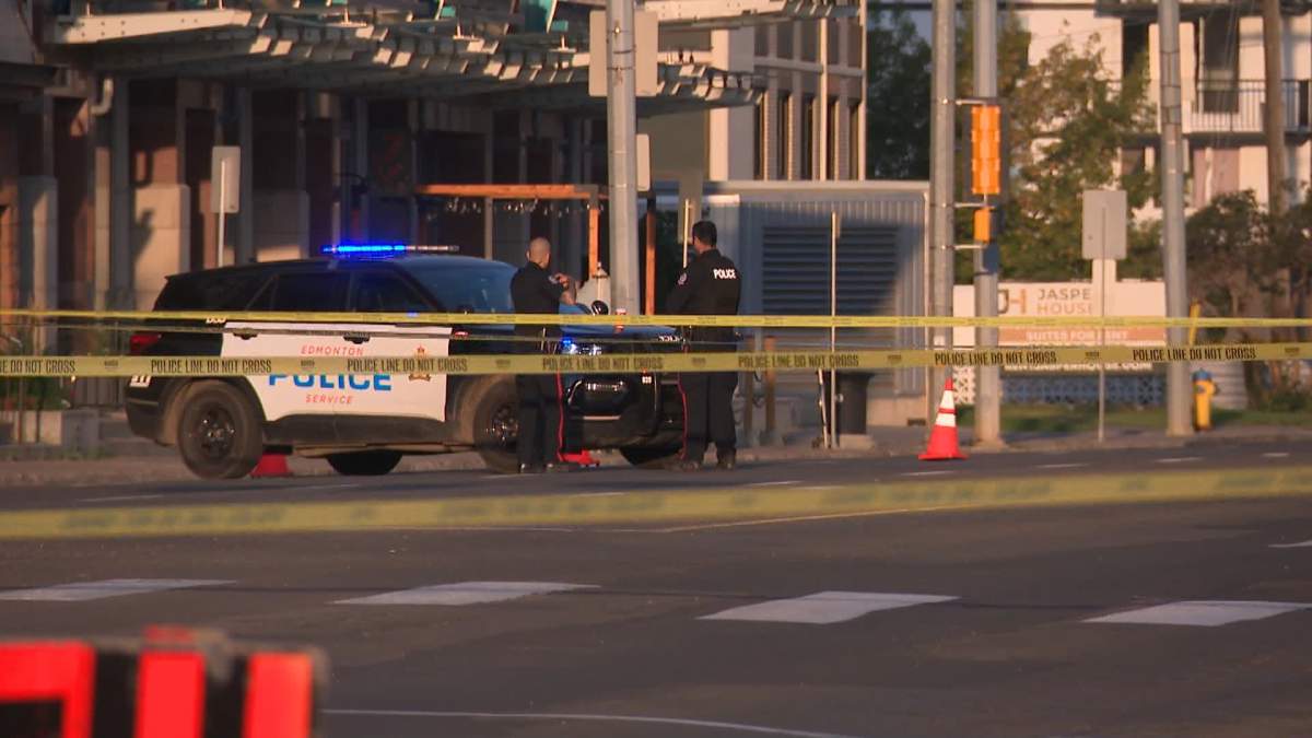 A stretch Jasper Avenue near 119 Street is blocked off by police tape as investigators search for more information on a shooting early Saturday morning in Edmonton.