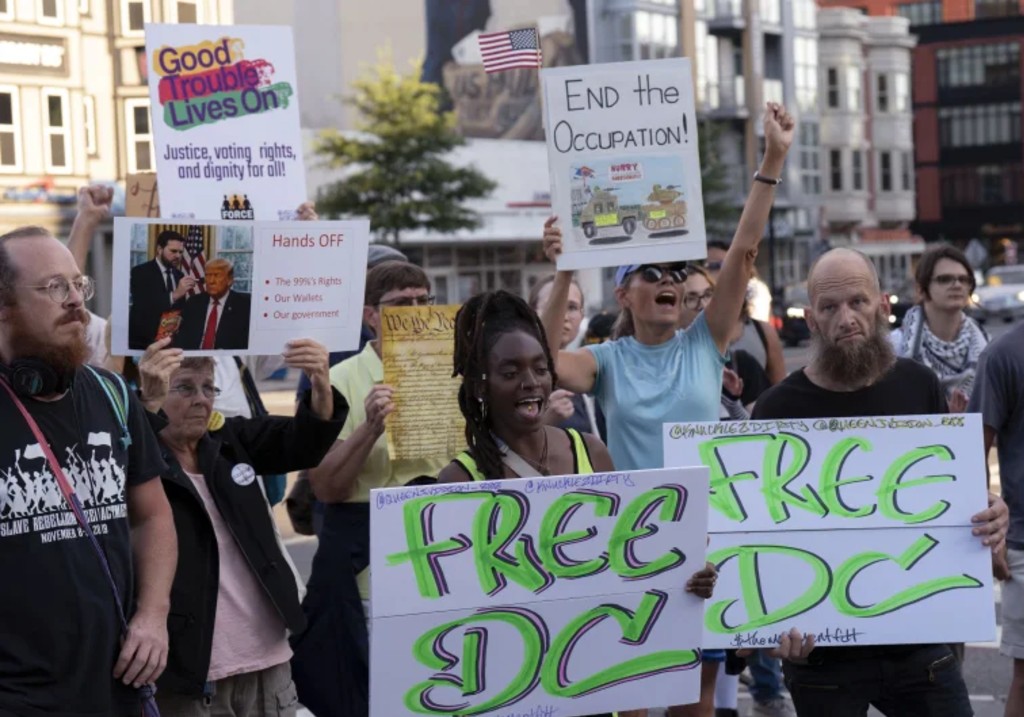People protest against President Donald Trump’s use of federal law enforcement and National Guard troops in the city during a rally along the U street corridor in northwest Washington, Saturday, Aug. 23, 2025.