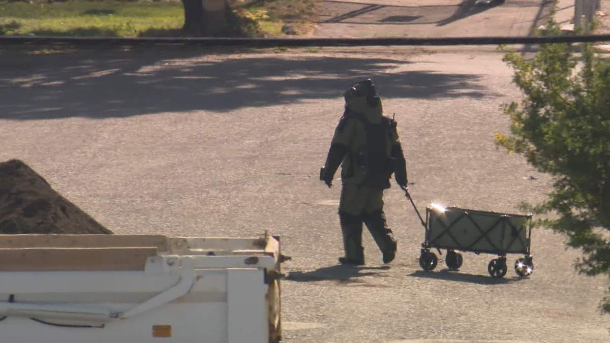 A member of the Calgary Police bomb disposal unit is seen helping to dispose of some highly volatile chemicals discovered outside a business in the city's Manchester Industrial Park on Tuesday, Aug. 27, forcing the evaucation of nearby homes and businesses.