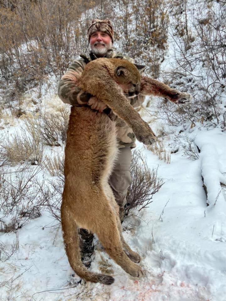 Asher Watkins poses with a dead mountain lion in this undated photo shared to his Facebook page.