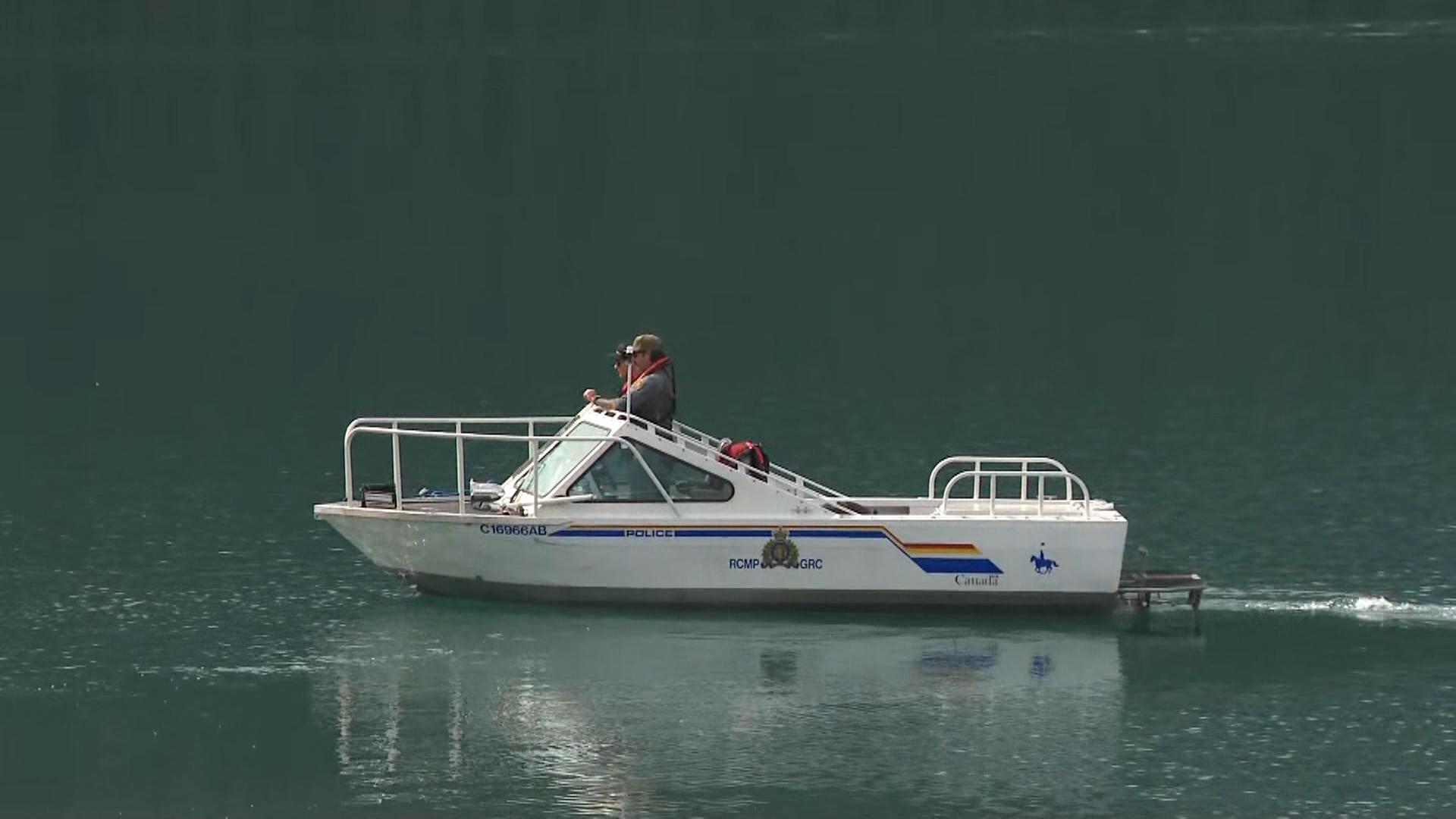 An RCMP boat is seen on Upper Kananaskis Lake on Thursday, a day after search and rescue crews were called in for reports a canoe had capsized with four people on board.