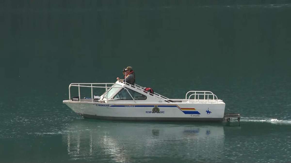 An RCMP boat is seen on Upper Kananaskis Lake on Thursday, a day after search and rescue crews were called in for reports a canoe had capsized with four people on board.