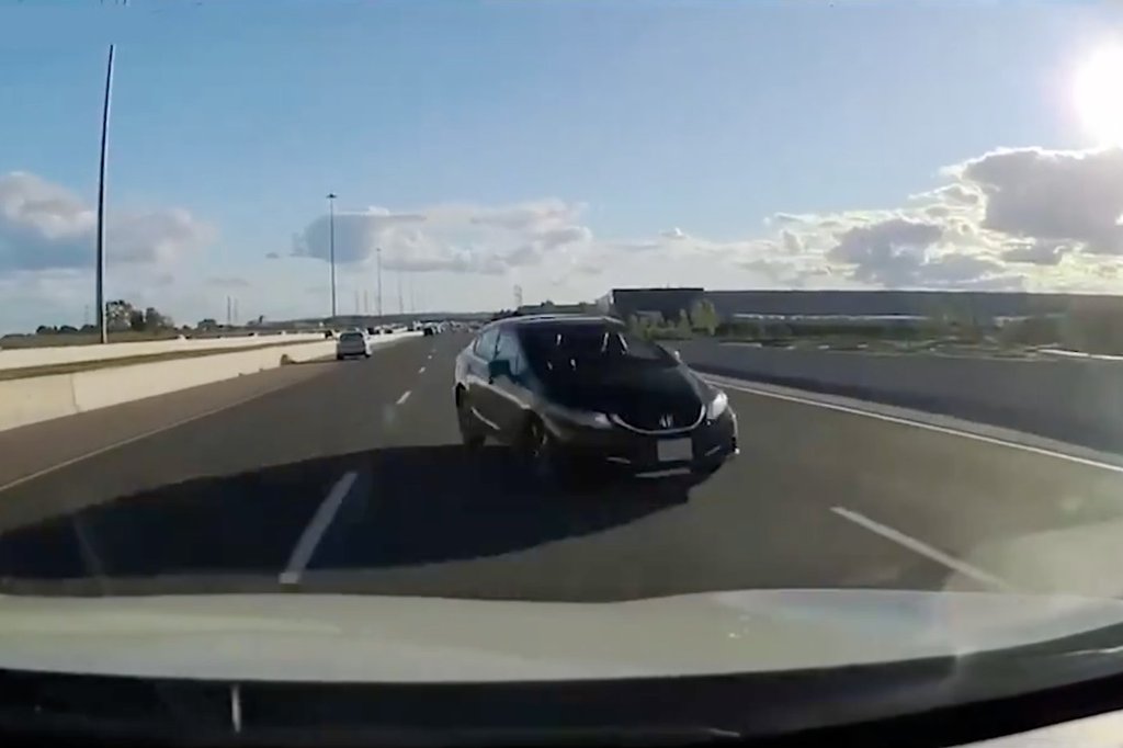 This still image from handout dashcam video, provided by the Ontario Provincial Police, shows a driver travelling eastbound in the westbound lanes of Highway 401 near James Snow Pkwy. on Sunday, Sept 7, 2025. 