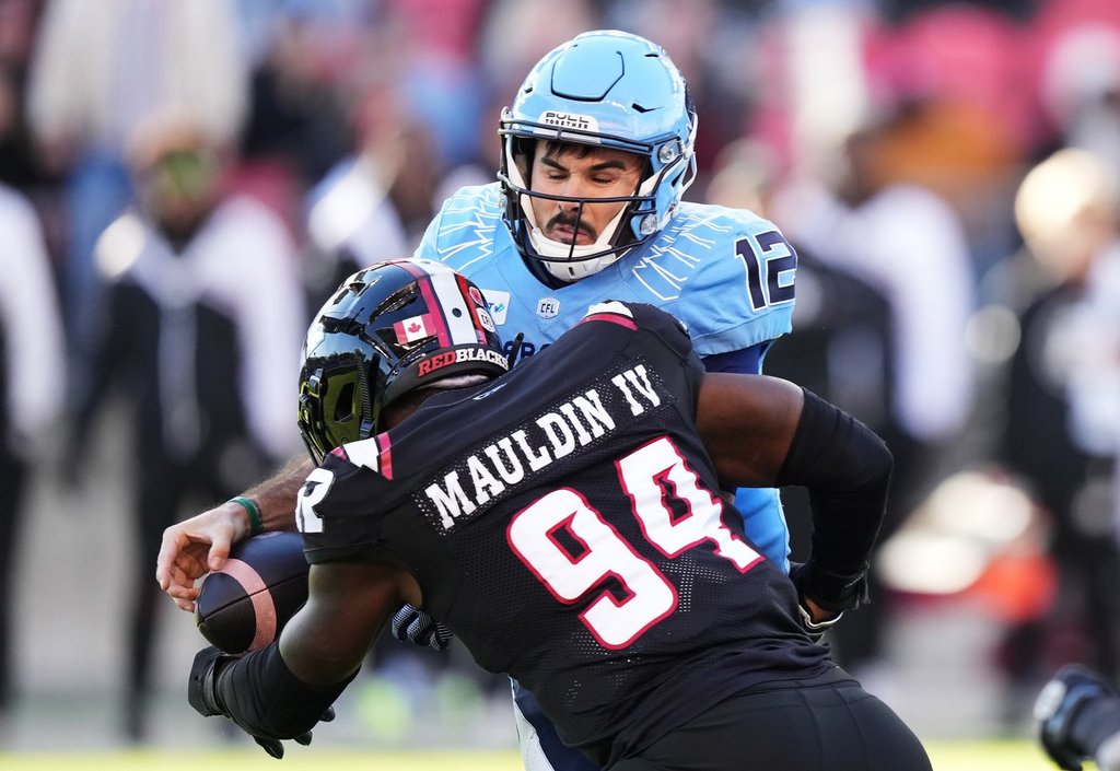 Ottawa Redblacks defensive end Lorenzo Mauldin IV (94) sacks Toronto Argonauts quarterback Chad Kelly (12) causing a fumble during first half Eastern Conference semifinal CFL football action in Toronto on Saturday, November 2, 2024. THE CANADIAN PRESS/Nathan Denette.