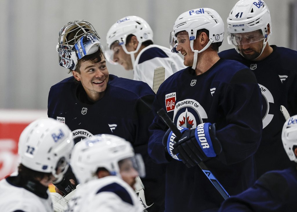Jets goaltender Eric Comrie (1) talks to Gustav Nyquist (14) during their NHL training camp session in Winnipeg on Thursday, Sept. 18, 2025. 
