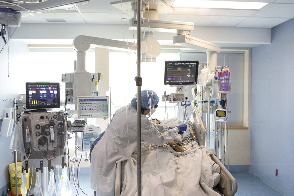 A nurse tends to a patient in the intensive care unit at the Bluewater Health Hospital in Sarnia, Ont., on Tuesday, January 25, 2022. The head of the Ontario Hospital Association says hospitals should not lose nurses and doctors to a new system of private clinics the government will be using to reduce the surgical backlog.THE CANADIAN PRESS/Chris Young.